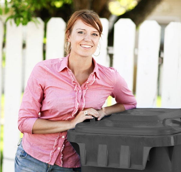 Woman stanidng next to trash bin
